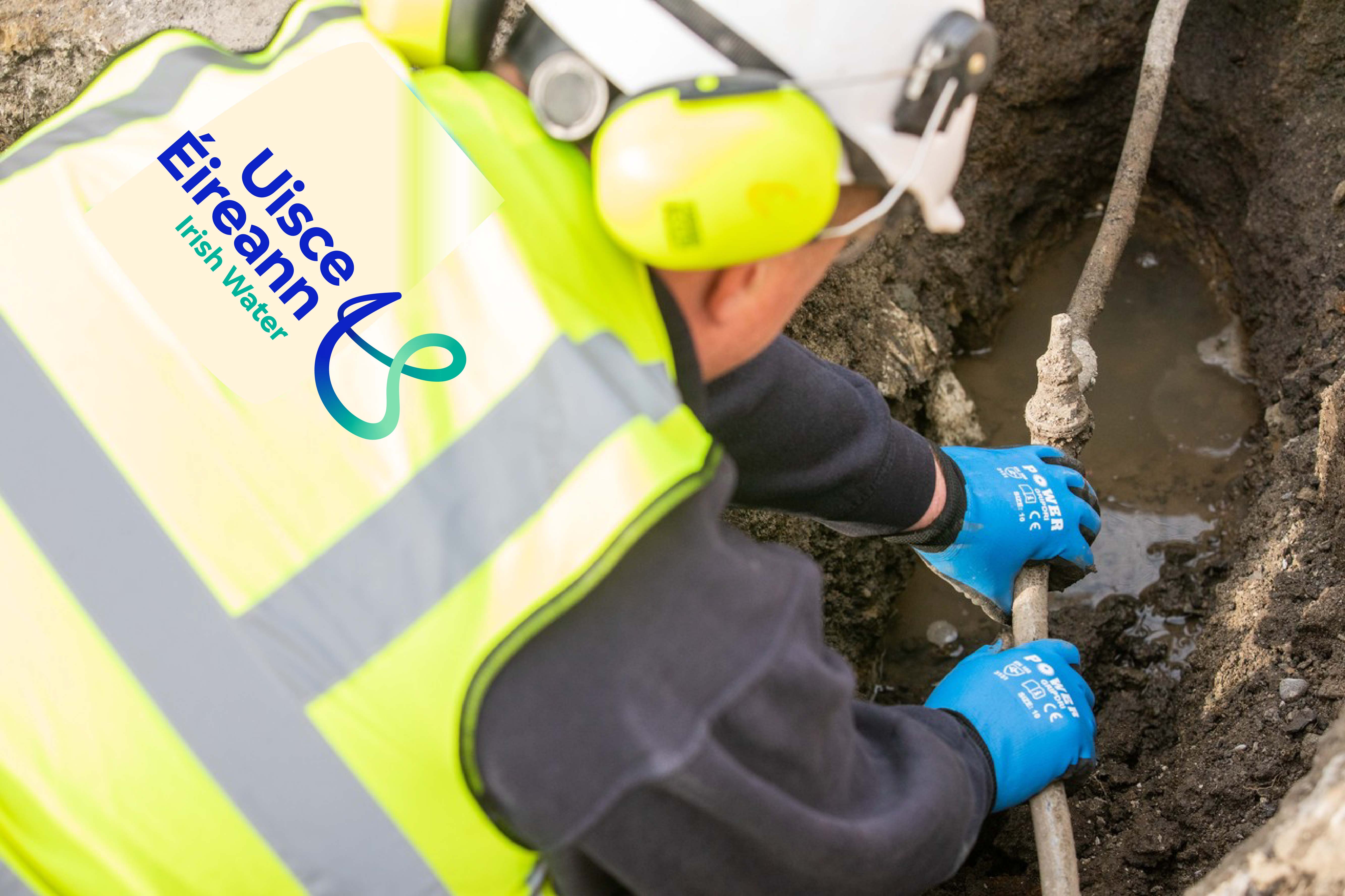 An Uisce Éireann worker fixing a small pipe in the ground