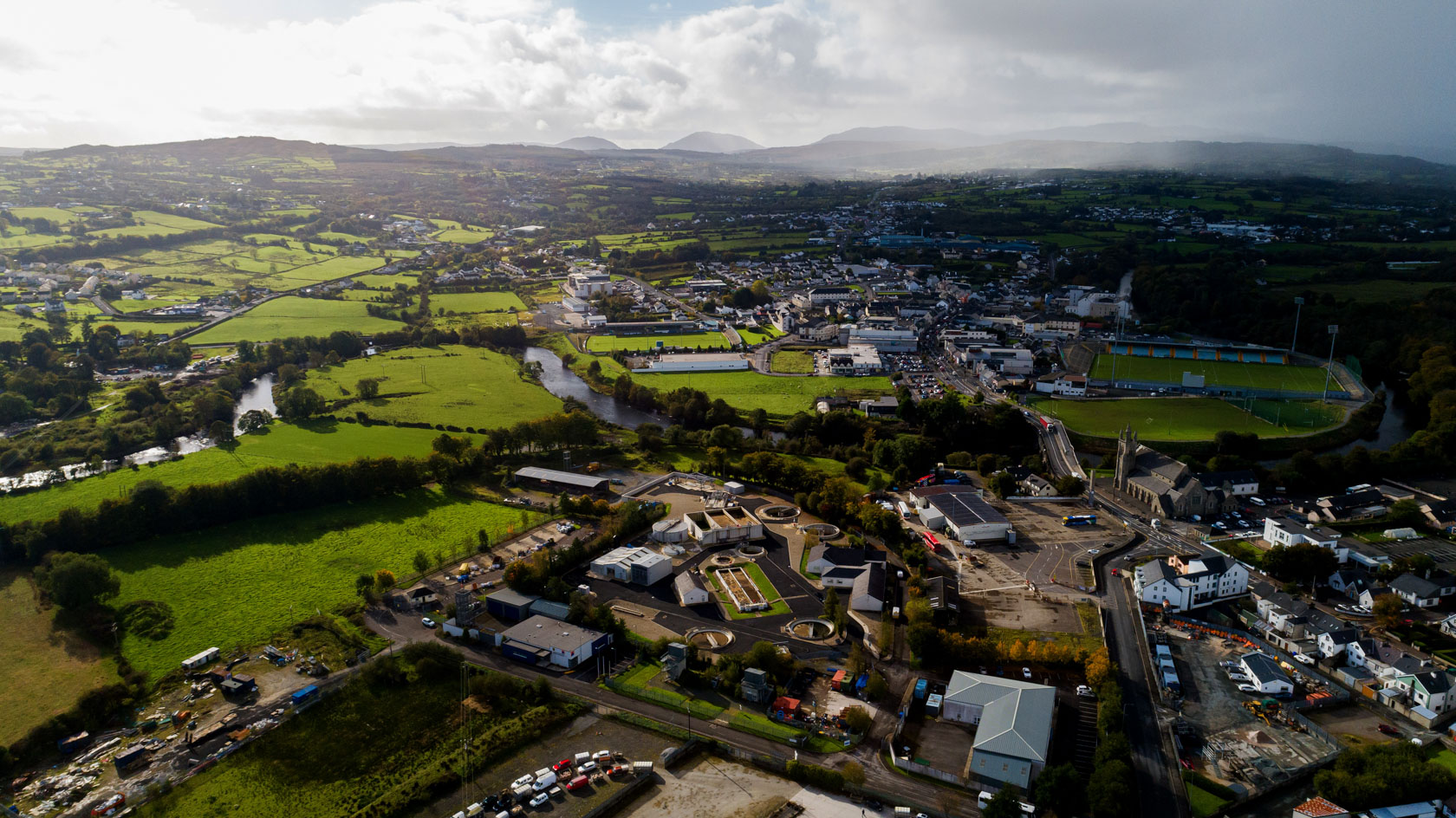 Aerial view of a town and many fields with mountains in the distance