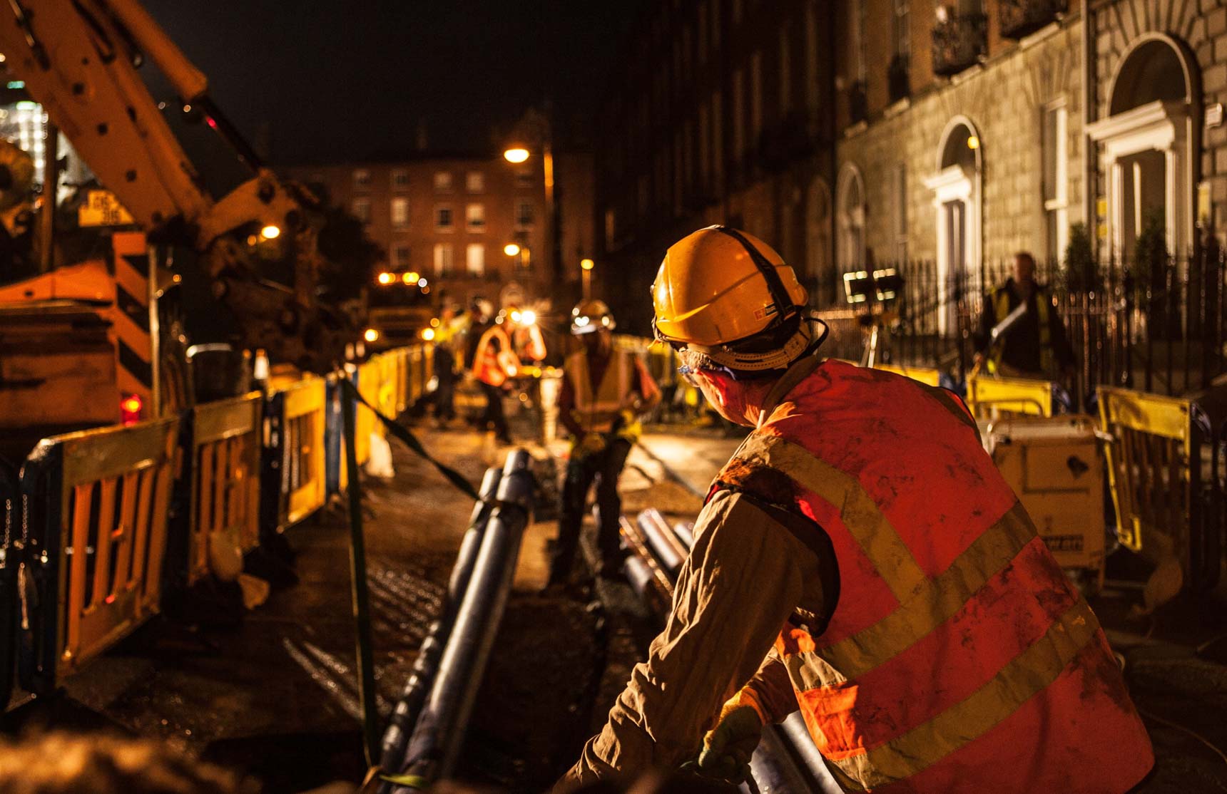 A worker working with pipes at night time