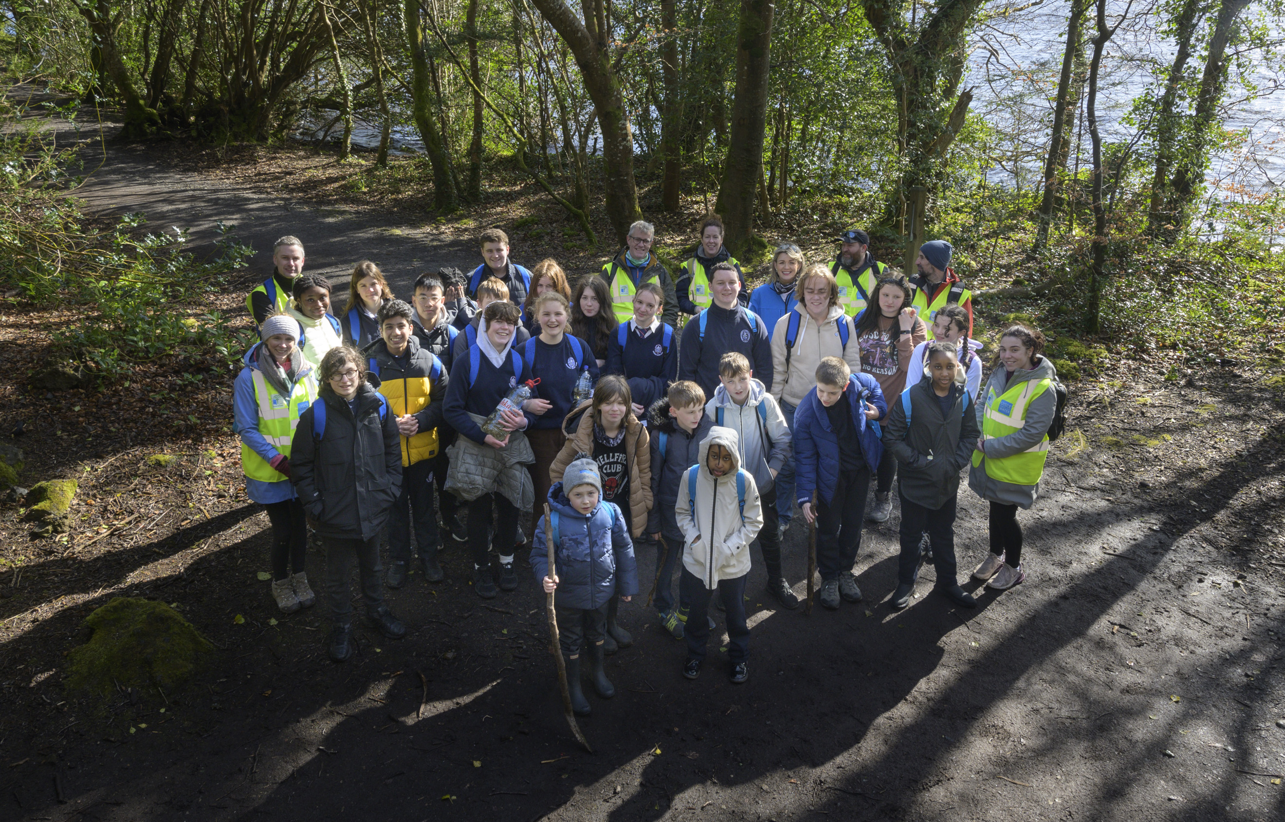 A group of schoolchildren and teachers in a wood