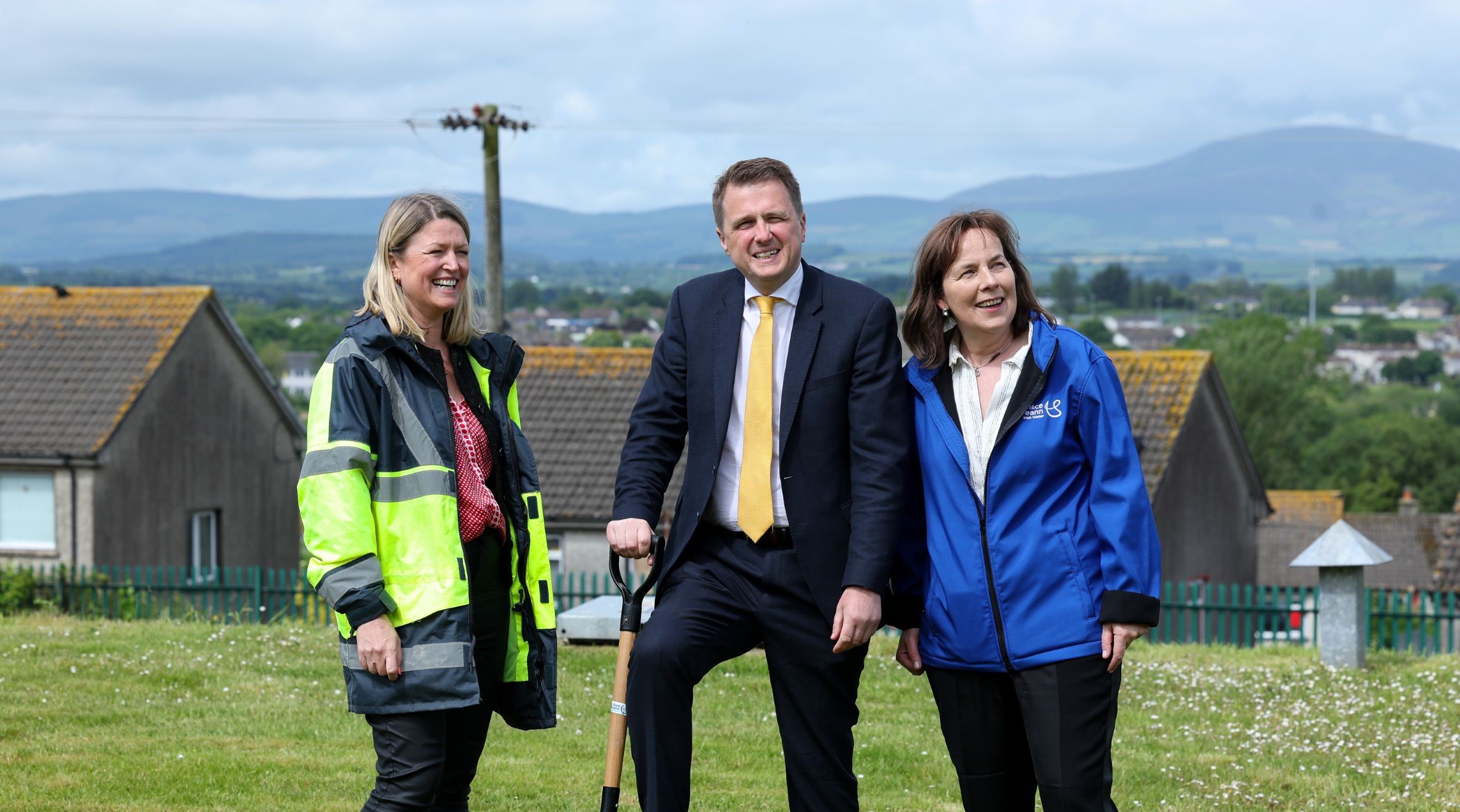 Three Uisce Éireann workers smiling with one holding a shovel