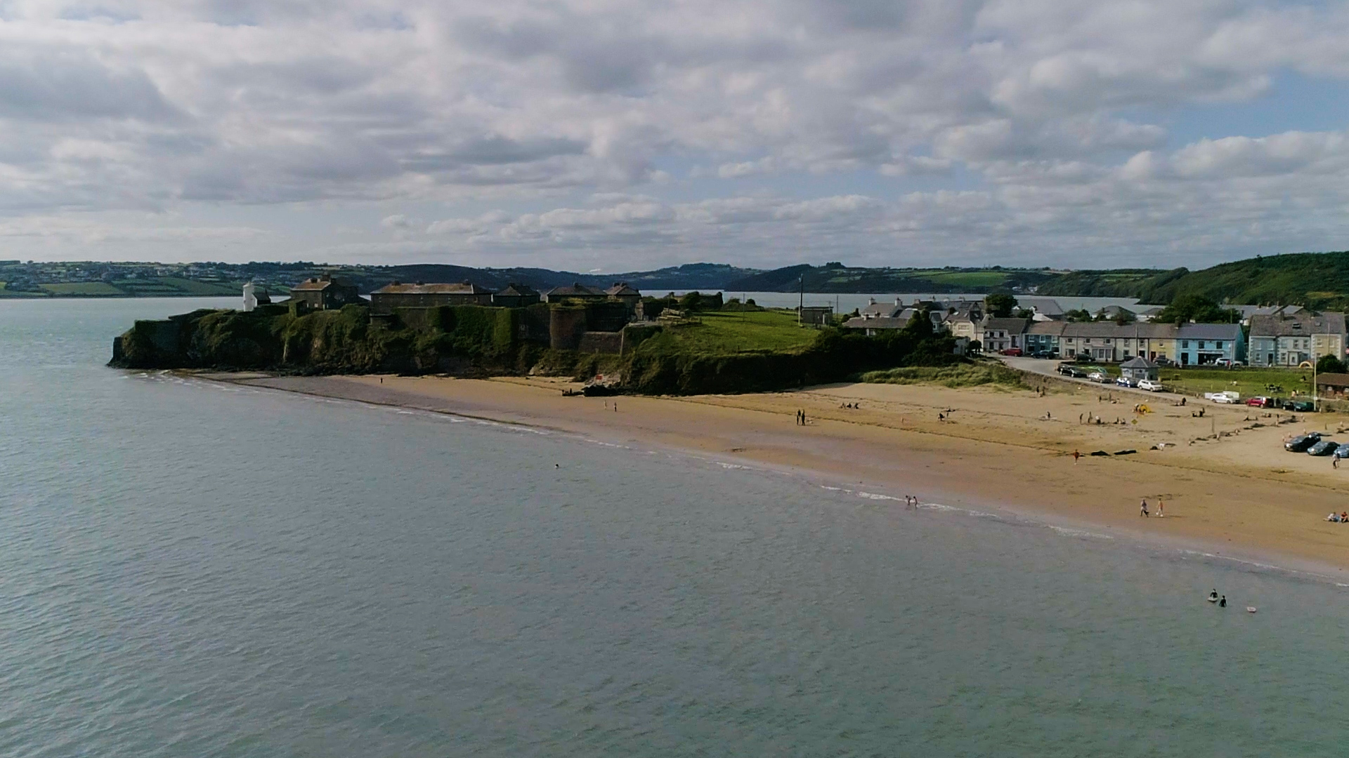 A beach with a village in the background