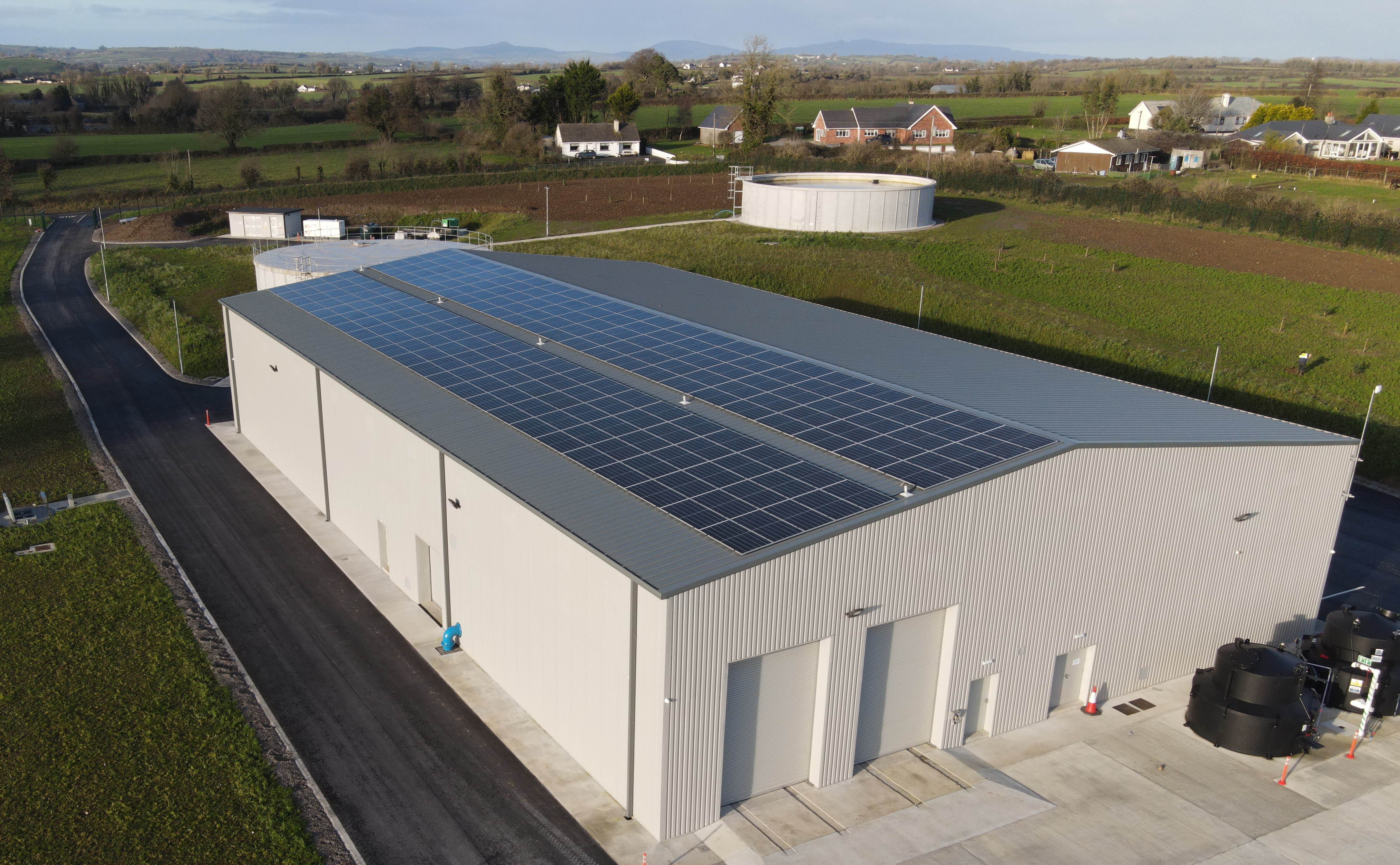 A large white building with solar panels on the roof