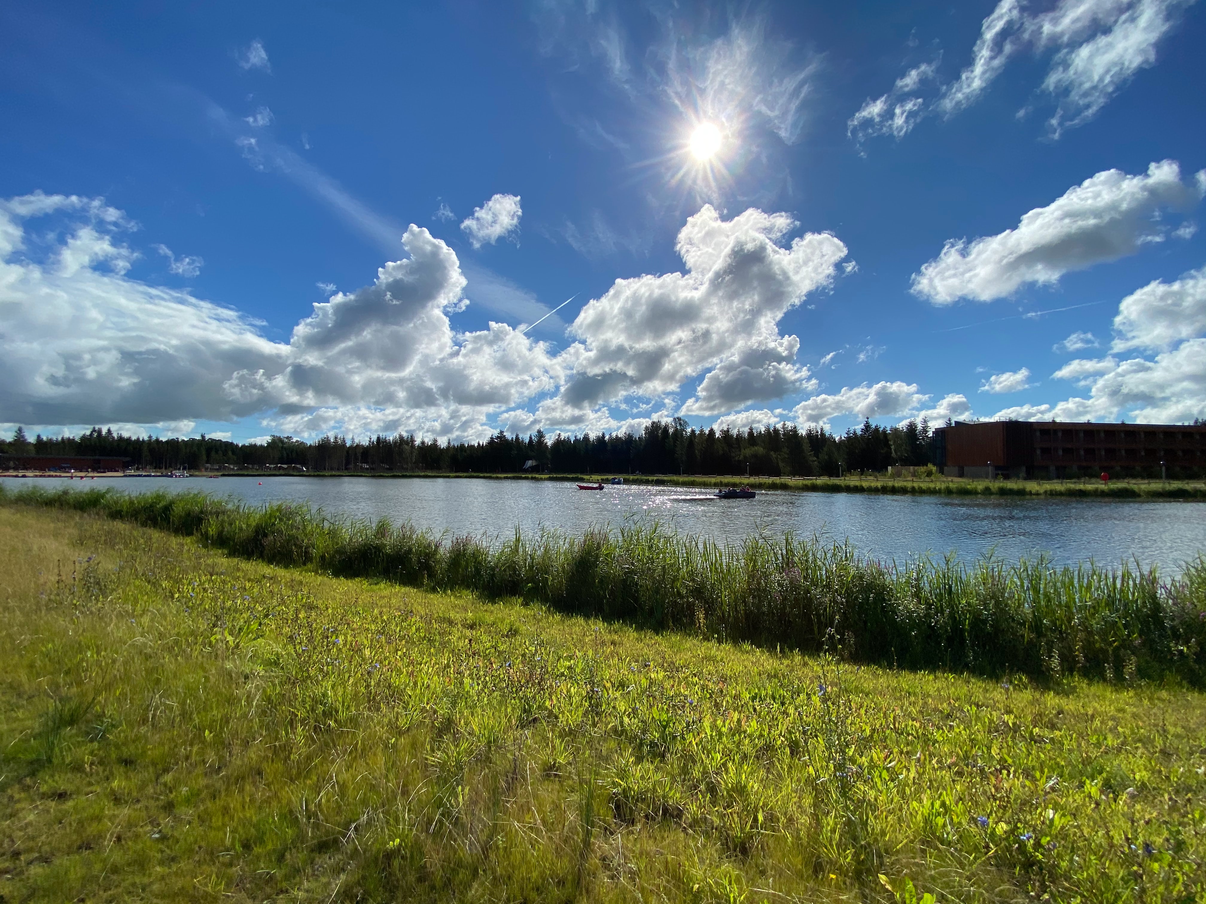 A large lake with some boats on a sunny day