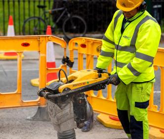 An Uisce Éireann worker working on a road