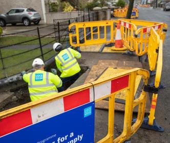 Uisce Éireann workers fixing pipes on a road