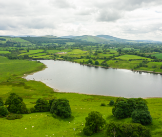 A lake surrounded by green fields